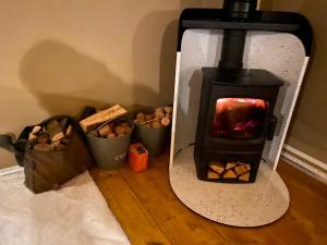 a stove with two buckets of peanuts in a room at Beautiful Lakeside Safari Lodge in Bruton