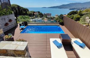 a swimming pool on a balcony with a view of the water at Villa Silvia Apartment - Private Pool in Zoagli