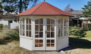 a white gazebo with a red roof at Hotel Seeburg in Sankt Peter-Ording