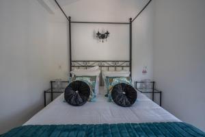 a bedroom with a bed with two pillows at Hôtel Le Méditerranée in Hyères