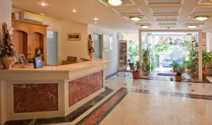 a lobby with a reception counter in a building at Dedalos Beach Hotel in Sfakaki