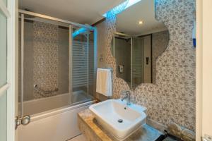a bathroom with a sink and a mirror at Adenya Hotel & Resort Halal All Inclusive in Avsallar