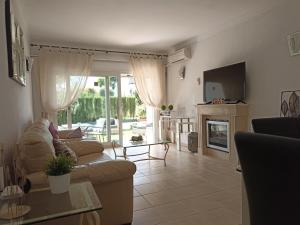 a living room with a couch and a fireplace at Le joyau Andalou in Estepona