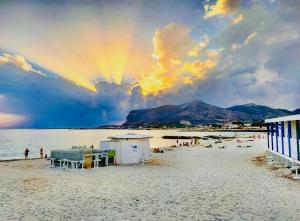 a beach with a group of people on the sand at Stabilimento Lido Burrone in Favignana