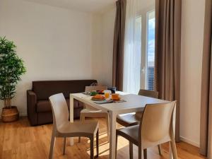 a dining room with a white table and chairs at Superior Beach Aparthotel in Lido di Jesolo