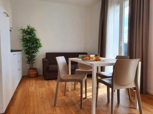 a dining room with a white table and chairs at Superior Beach Aparthotel in Lido di Jesolo
