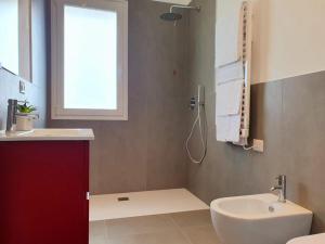 a bathroom with a sink and a toilet and a shower at Superior Beach Aparthotel in Lido di Jesolo