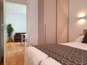 a bedroom with a bed and a living room at Superior Beach Aparthotel in Lido di Jesolo