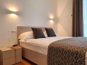 a bedroom with a bed with two pillows on it at Superior Beach Aparthotel in Lido di Jesolo