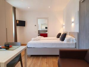 a bedroom with a large white bed in a room at Superior Beach Aparthotel in Lido di Jesolo
