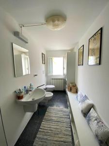 a bathroom with two toilets and a sink and a mirror at NOVECENTO in Monopoli