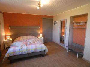 a bedroom with a bed with a wooden headboard at La mare aux grenouilles in Bruailles