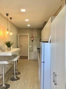 a kitchen with a blue refrigerator and a counter at Alojamento Amélie - Apartamento in Braga