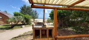 a wooden structure with a beehive next to a beach at Bay View Lodge in Miramar