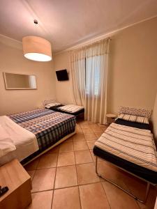 Postel nebo postele na pokoji v ubytování Albergo Africa