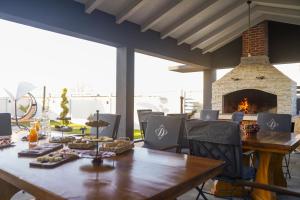 a dining room with a table and a fireplace at D-Palace-Lux in Donji Zemunik