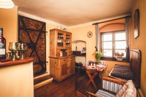 a room with a kitchen with a table and a window at Pension Cert a Kaca in Český Krumlov