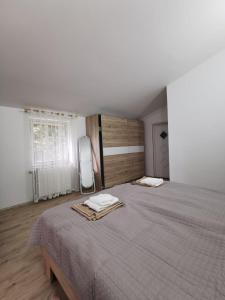 a bedroom with a large bed with two towels on it at Nikol in Karlovac