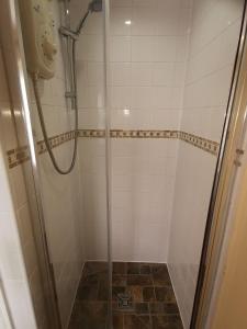 a bathroom with a shower with a glass door at Town House B & B in Skipton