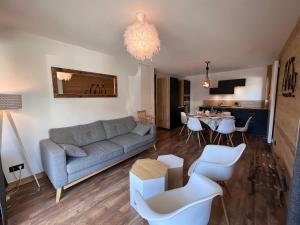 a living room with a couch and a table at Elan 12 - Très bel appartement centre village in La Clusaz