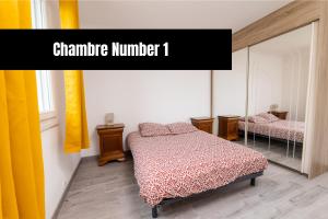 a bedroom with a bed and a mirror with the words champagne number at Chambre hote - Dormir comme à la maison - in Châteaubriant