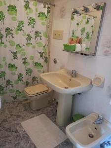 a bathroom with a sink and a toilet at Albergo Stella in Tolè