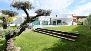 a villa with a swimming pool and a house at Villa Waterfall - Clever Details, luxury, 5min walking from the center in Vilamoura