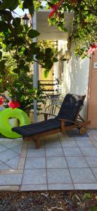 a bench sitting on top of a patio at CLEO ROOM WITH YARD IN MALIA 250m FROM THE BEACH in Malia