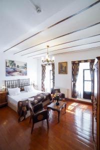 a bedroom with a bed and a couch and a table at Sarnıç Butik Otel in Istanbul
