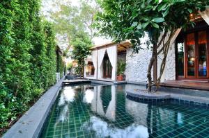 ein Schwimmbad vor einem Gebäude in der Unterkunft The Journey Resort Pattaya in Na Jomtien