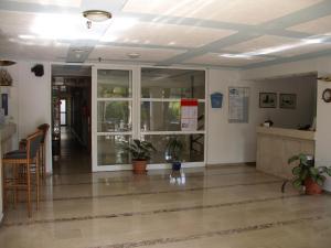 a lobby of a building with glass doors and plants at Aegeon Hotel - Adults Only in Kos