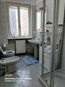 e bagno con servizi igienici, lavandino e doccia. di Appartamento Incantevole:Castelnuovo del garda a Castelnuovo del Garda
