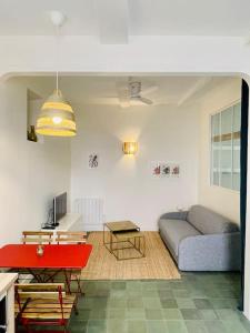 a living room with a couch and a red table at LA MOUNINE - Hyper centre - 37m2 - 4 pers in Cassis +13 photos