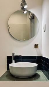 a bathroom with a large white tub and a mirror at LA MOUNINE - Hyper centre - 37m2 - 4 pers in Cassis +13 photos