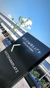 a sign for a car dealership on display in front of a building at Roomreich in Ingolstadt