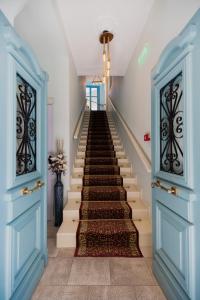 a stairway with blue doors and a staircase with stairsngthngthngthngthngth at 999 Luxury Hotel in Nafplio