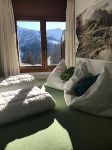 a room with two white pillows and a window at Lärchenwald Lodge in Bellwald