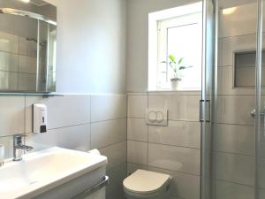 a bathroom with a sink and a toilet and a window at Lovely Sea View House in Malinska Island Krk in Malinska +63 photos