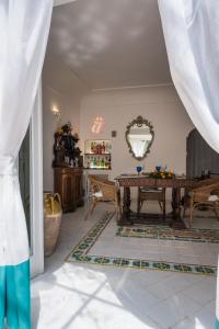 a living room with a table and chairs at CasaMia Positano - sea view and private outdoor hot tub in Positano