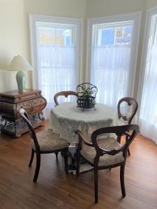 a dining room with a table and two chairs and a table with a tableablish at Seabank House Bed and Breakfast Aloha in Pictou