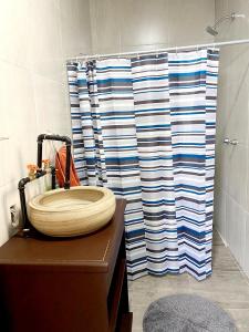 La salle de bains est pourvue d'un lavabo et d'une douche. dans l'établissement Sol y Luna Teotihuacan, à San Sebastian Xolalpa
