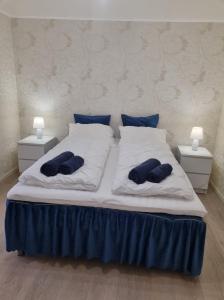 a large bed with two blue pillows on it at Holiday apartment in Kleppstad
