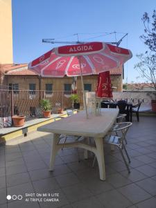 a table and chairs with an umbrella on a patio at Il Ragno D`Oro in Rho