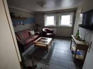 a living room with a couch and a coffee table at Casa Hibiscus in Putbus