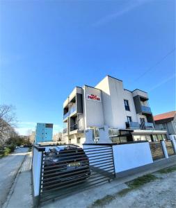 a building with a fence in front of it at Vila Matei - Eforie Nord in Eforie Nord