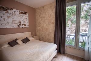 a bedroom with a bed and a large window at La Casa del Gelsomino in Ragusa