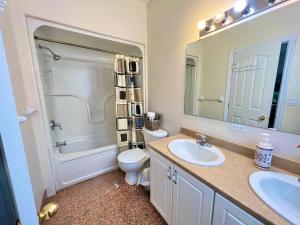 a bathroom with a sink and a toilet and a mirror at Main Suite in Kingston