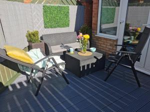 a patio with a table and a chair and a table at Benjamin Gardens Holiday Home in Great Driffield
