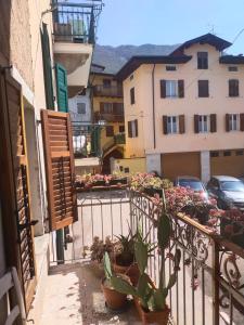 a balcony with potted plants and a building at La tana dell'artista in Arco
