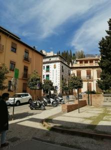 a group of motorcycles parked in a parking lot at Casa Epi - Encantador apartamento en el centro de Granada - Barrio Realejo in Granada
